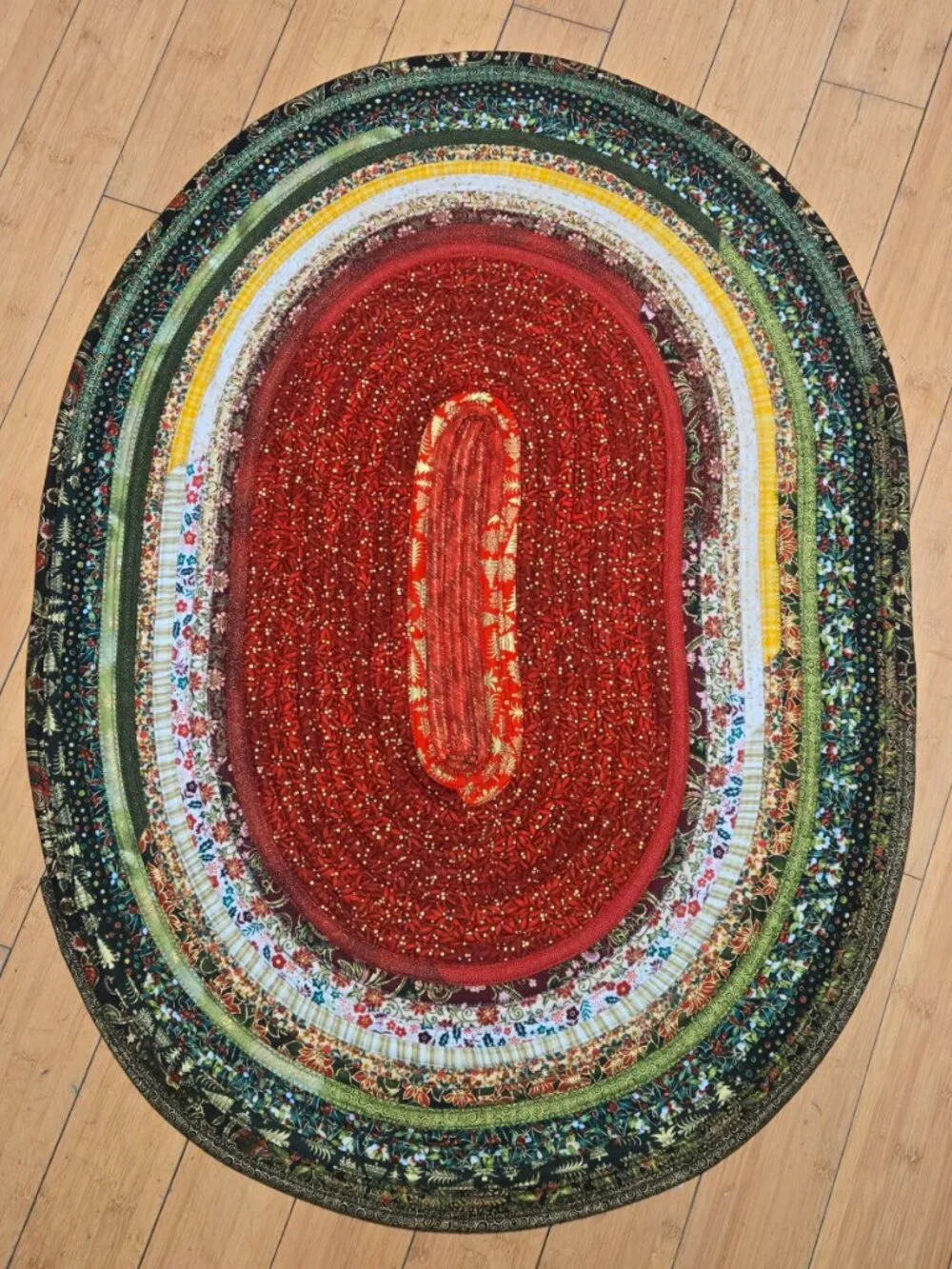 Christmas Jelly Roll Oval Rug in Traditional Christmas Colors